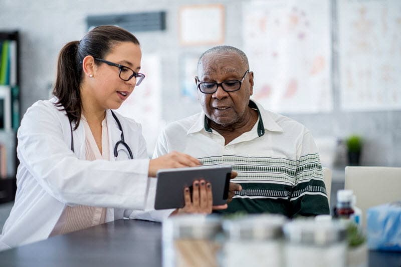 Doctor discussing genetic screening results with patient